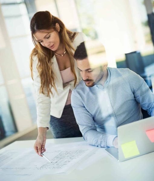 Business people working on laptop computer in office